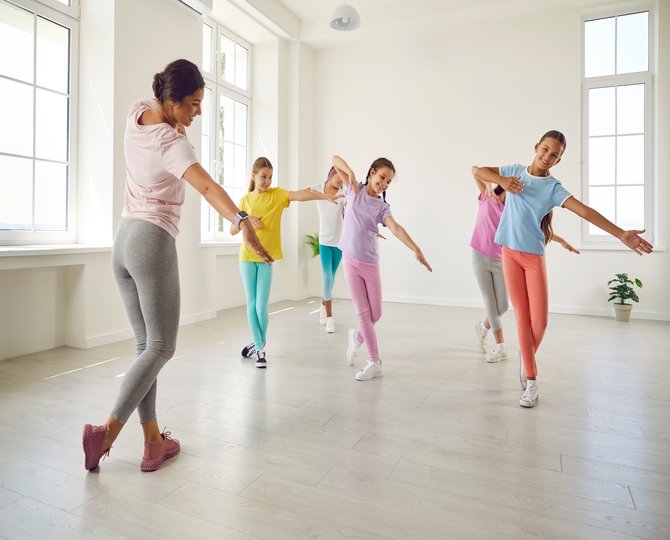 Smiling,happy,girls,training,modern,dance,moves,together,in,studio